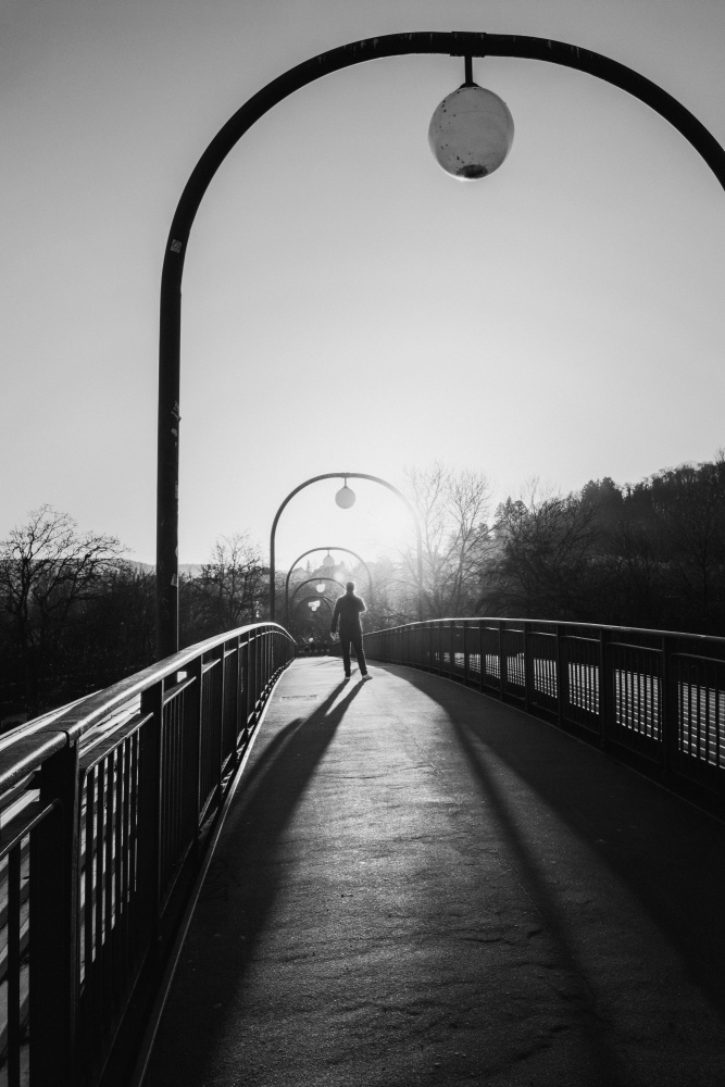 Man in backlight on a bridge a Eiji Yamamoto