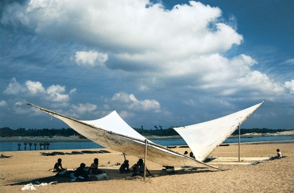 Fishermen mending their nets under shade of triangular sails, Gopalpur (photo)  a 