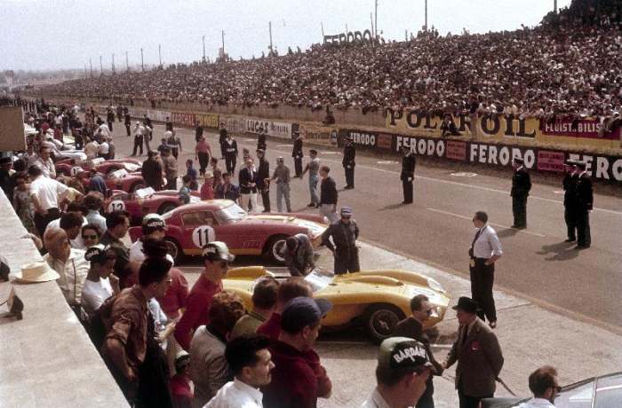 Le Mans racing circuit, France. The cars are lined up in the pits, with the spectator stands opposit a 