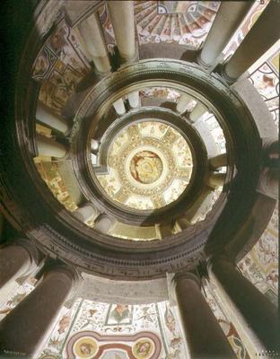 View of the stone spiral staircase looking up towards the ceiling, designed by Jacopo Vignola (1505- a 
